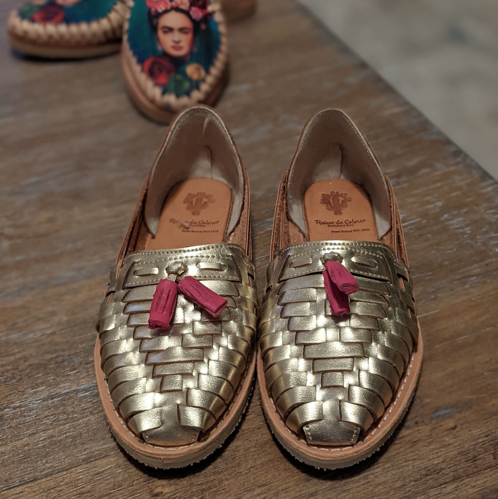 Gold huaraches with pink tassel